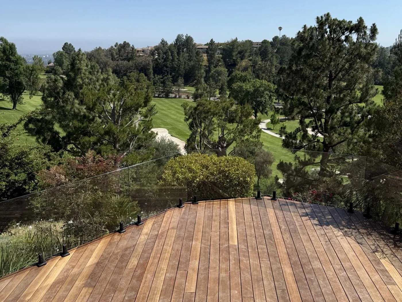 Frameless glass deck railing we installed on a California hillside deck overlooking a golf course