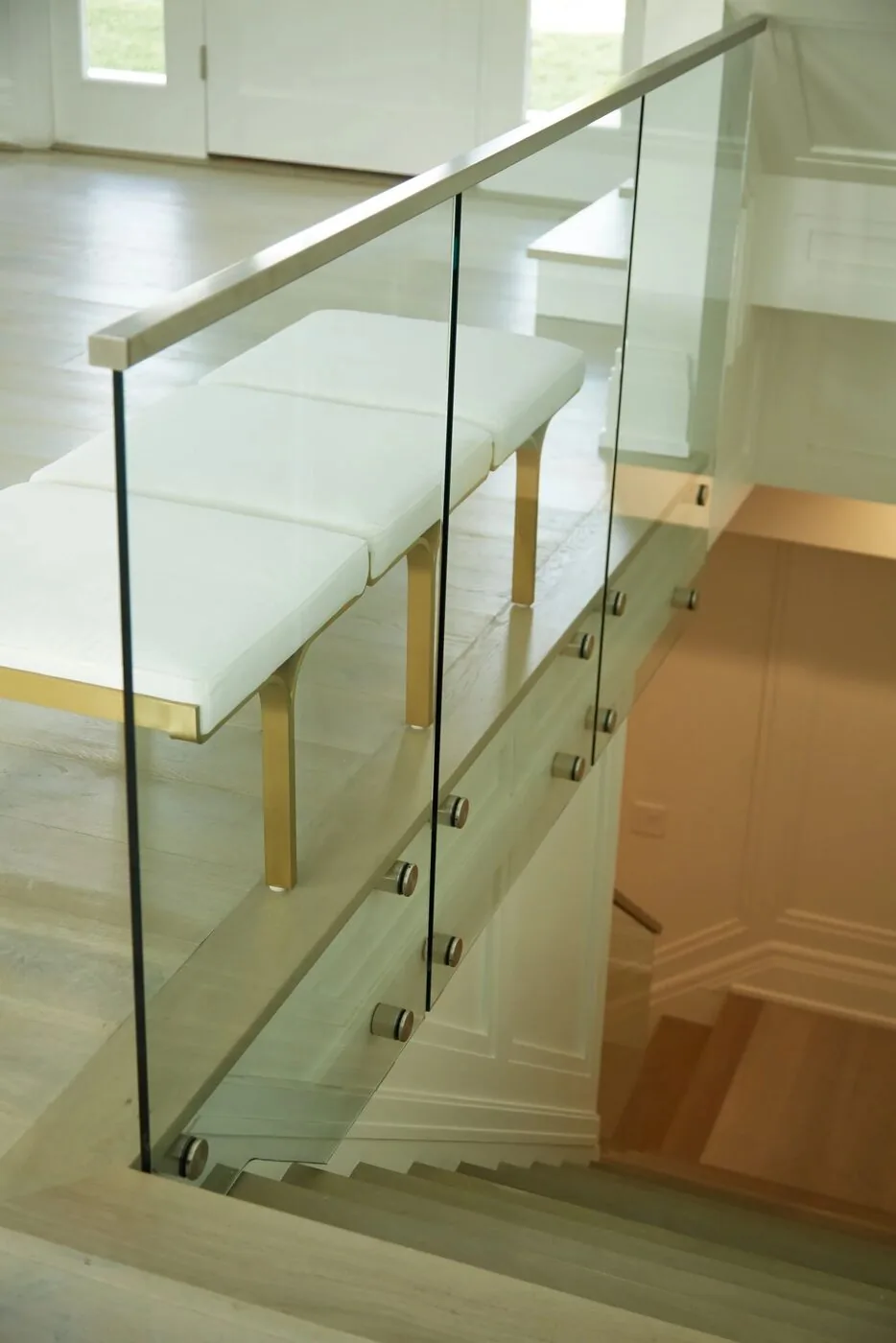 Frameless glass stair railing on stainless standoffs that we fabricated and installed in a California home